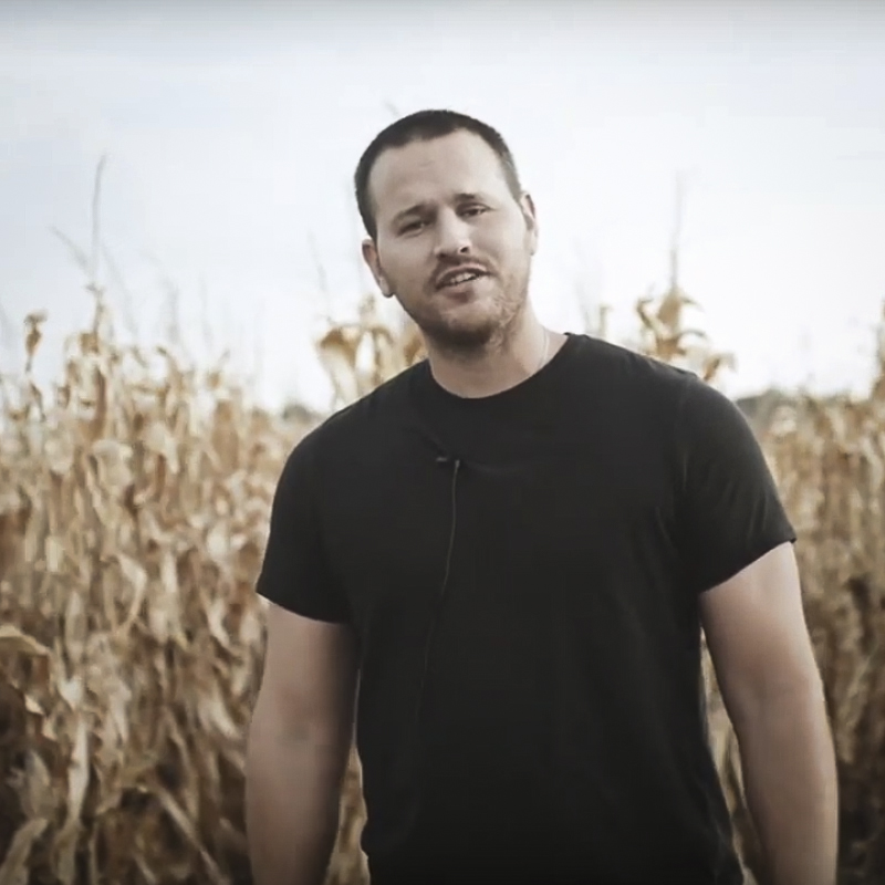 Ray standing near corn field.