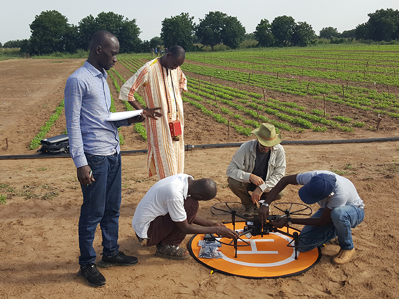 Men around drone