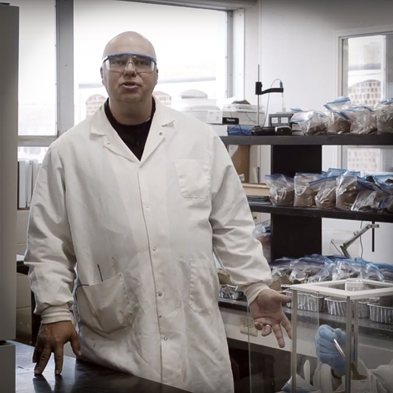 David wearing lab coat and safety glasses.