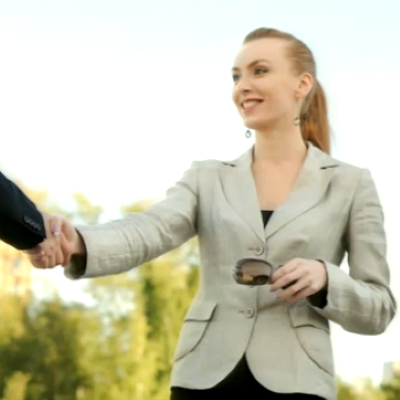 woman outside shaking hands