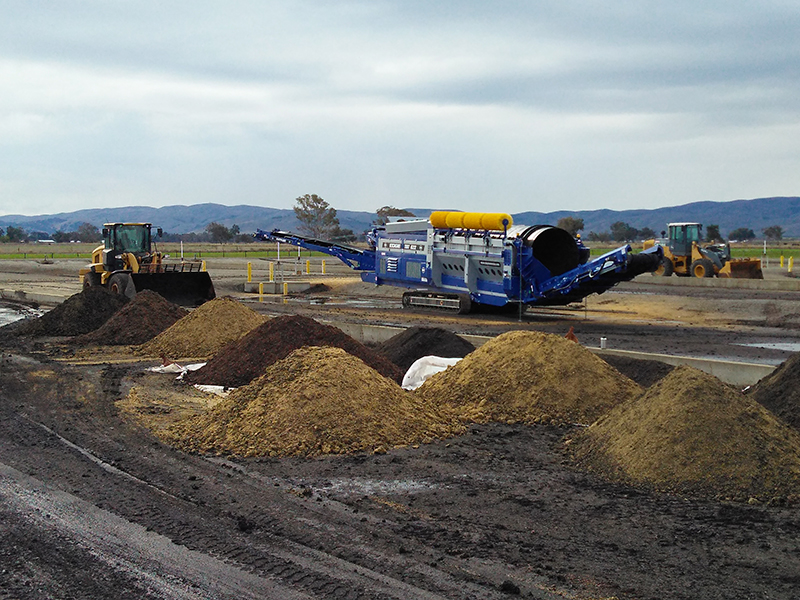 large equipment surrounded by piles of soil-like substance