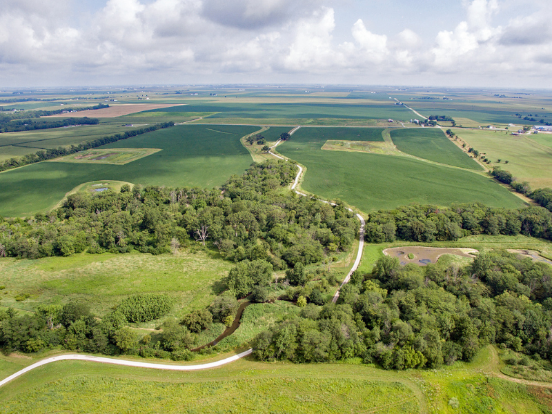 bird's eye view of several farm fields, trees, creeks and agricultural areas