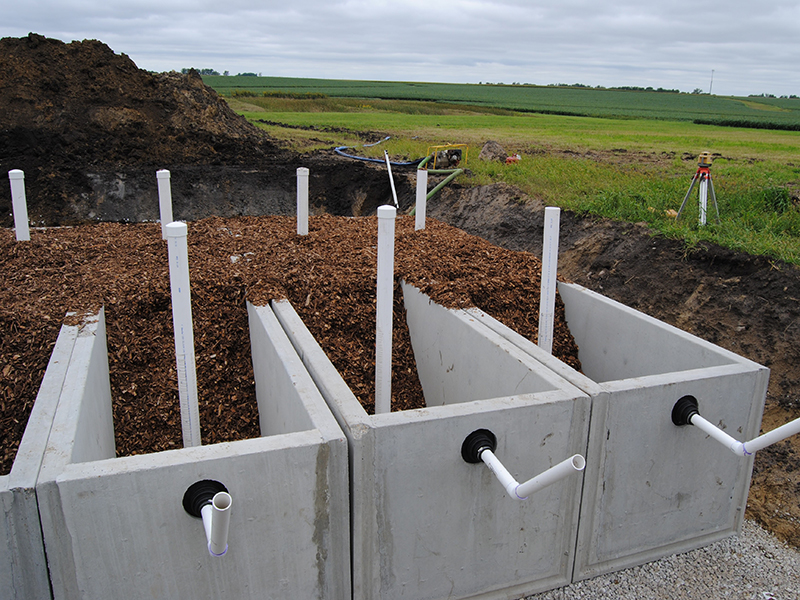 Bioreactor concrete walls are filled with woodchips and PVC tubing for water flow monitoring.