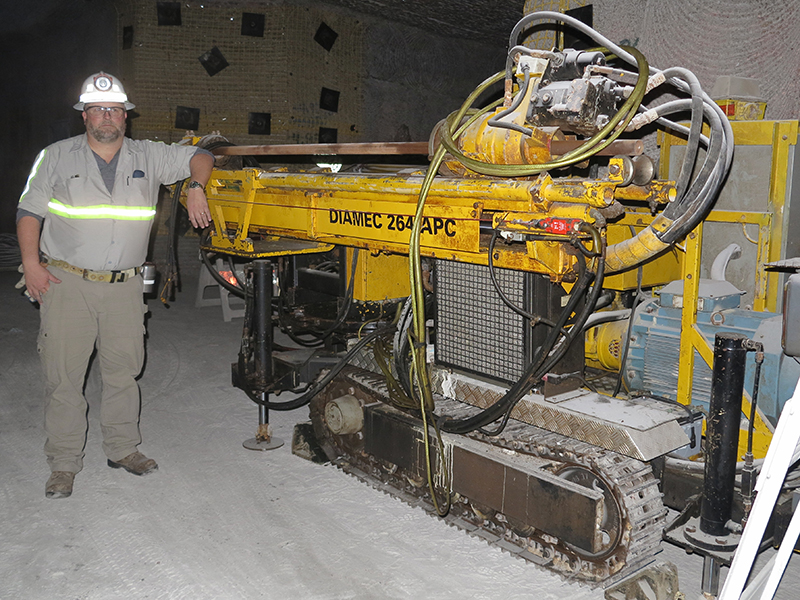 Man next to large equipment.