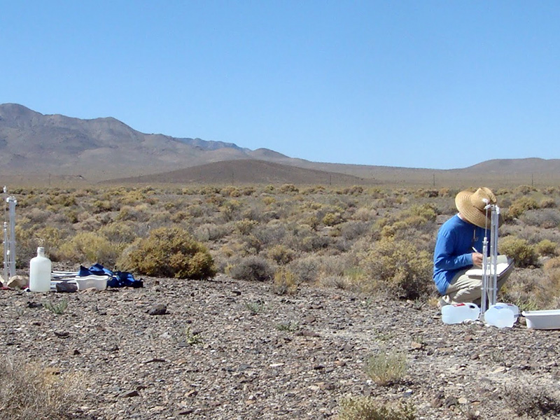 Researcher measuring infiltration in desert.