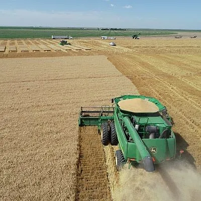 Harvester running through a field